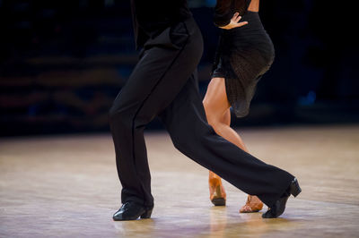 Low section of couple dancing on floor