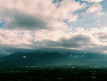 Cityscape against cloudy sky