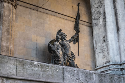 Low angle view of statue against building