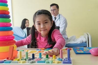 Portrait of a smiling girl sitting on table