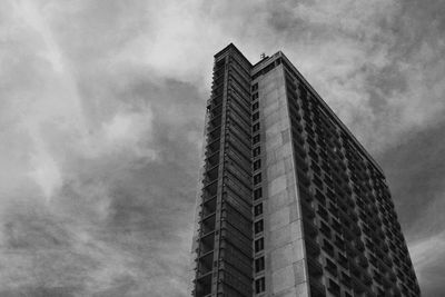 Low angle view of modern building against cloudy sky