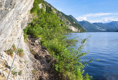 Scenic view of sea and mountains against sky