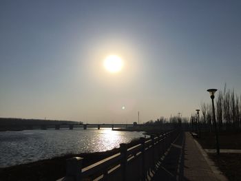 Scenic view of street against sky during sunset