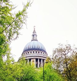 Low angle view of building and trees against sky