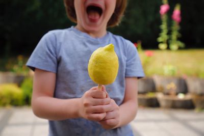 Midsection of boy holding ice cream