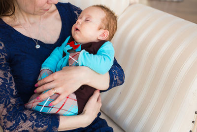 Midsection of mother and daughter baby