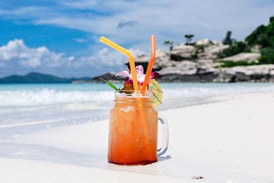 Drink in glass jar at beach