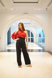 Portrait of beautiful woman standing in corridor