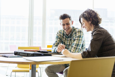 Professor and student talking in classroom