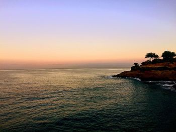 Scenic view of sea against clear sky during sunset