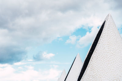 Low angle view of building against cloudy sky