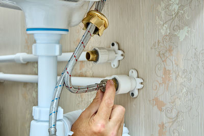 Cropped hand of man repairing machinery