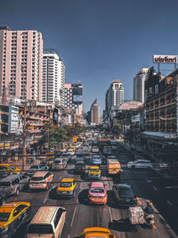 Traffic on city street and buildings against sky