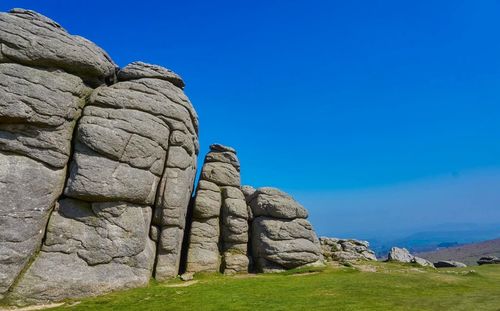 Stack of rocks against blue sky