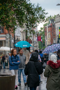 People standing on street in rain