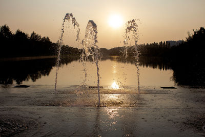 Scenic view of lake against sky during sunset