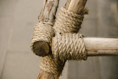 Close-up of rope tied on wood