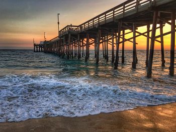 Pier on sea at sunset