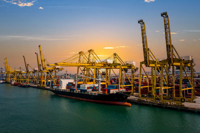 Commercial dock by sea against sky