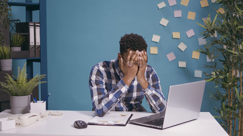 Frustrated man with laptop at office