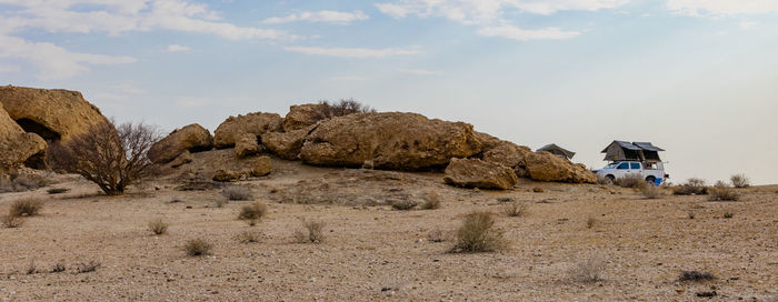 Rock formations on land against sky