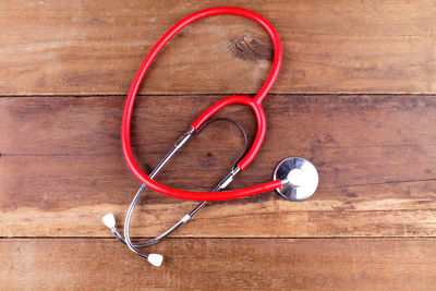 Directly above shot of red stethoscope on table