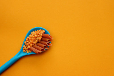 High angle view of pills on yellow background