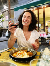 Portrait of smiling friends having food at restaurant