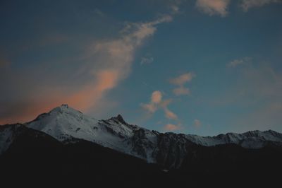 Scenic view of snowcapped mountains against sky during sunset