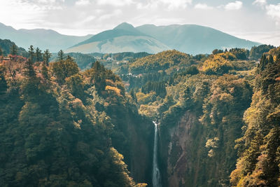 Scenic view of trees and mountains against sky