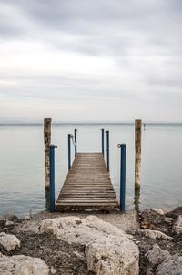 Pier over sea against sky