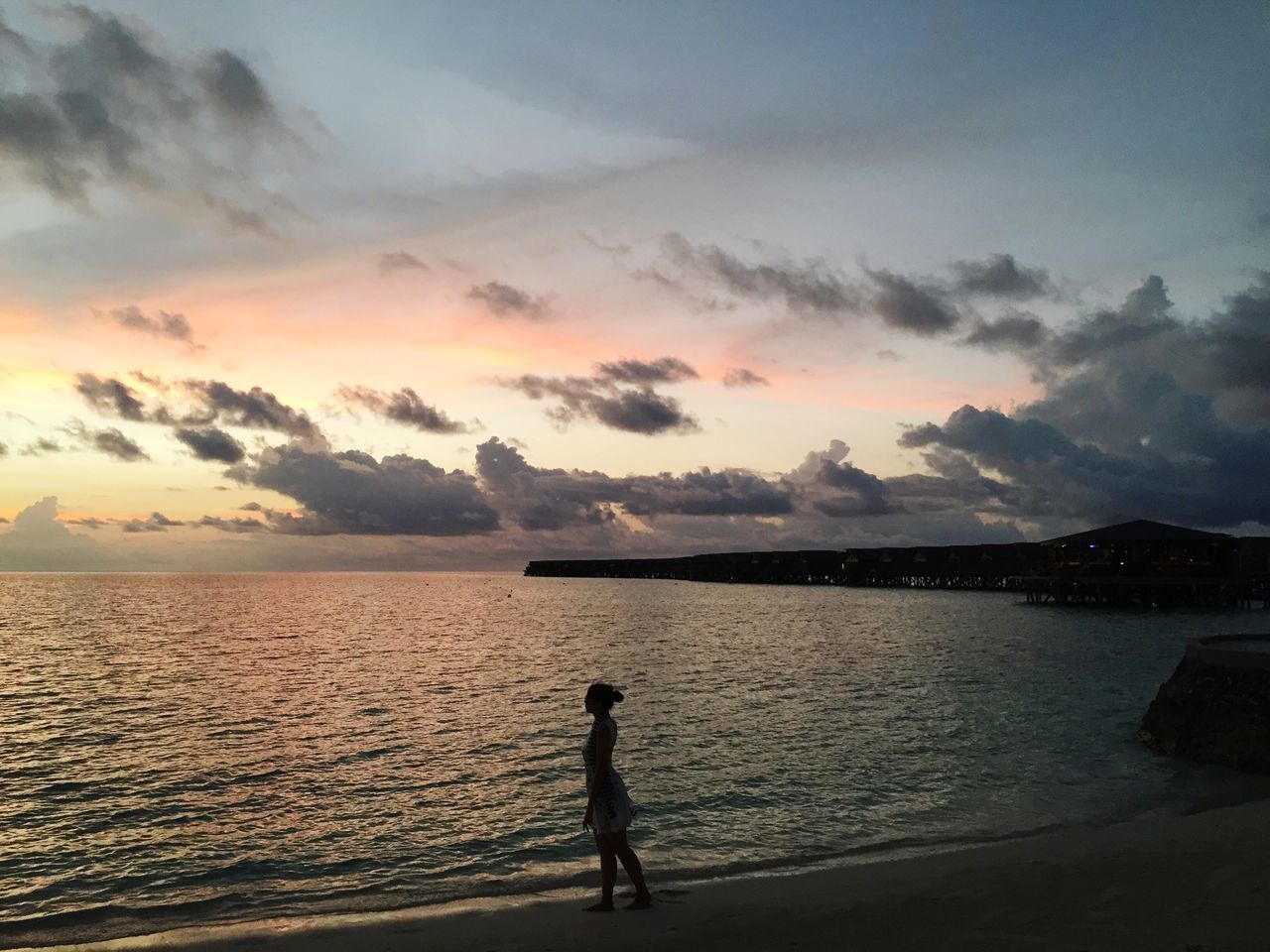 water, sunset, silhouette, sea, sky, scenics, tranquil scene, beauty in nature, tranquility, lifestyles, leisure activity, beach, nature, standing, idyllic, cloud - sky, shore, men