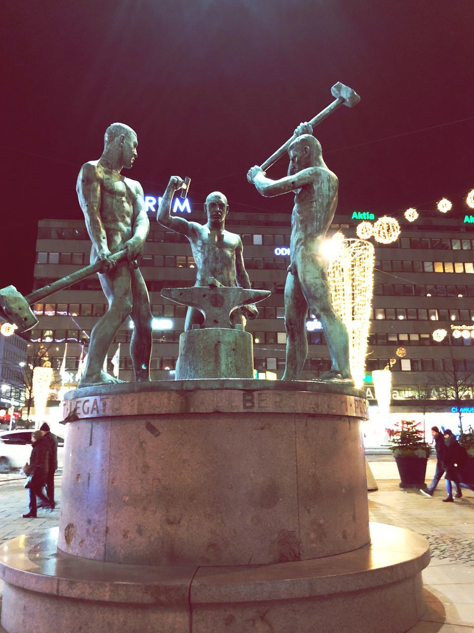 statue, sculpture, night, human representation, outdoors, illuminated, carousel, city, no people, sky