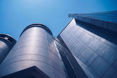 Low angle view of modern building against blue sky