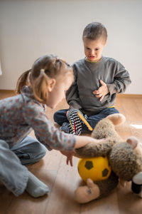 Boy playing with teddy bear