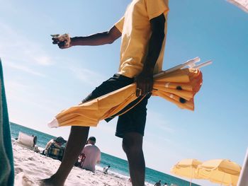 Low angle view of man on beach against sky