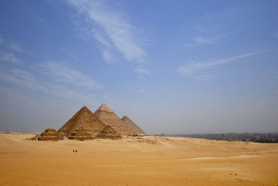 View of pyramids in desert against sky