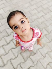 Portrait of cute baby girl lying on floor