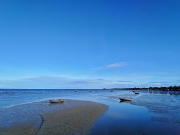 Scenic view of sea against blue sky
