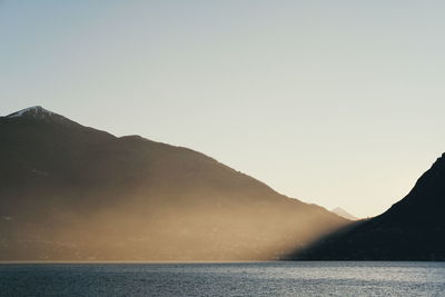 Scenic view of sea against clear sky during sunset