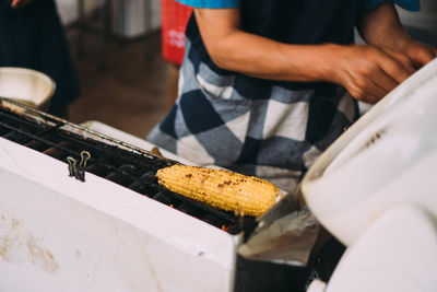 Midsection of man preparing food