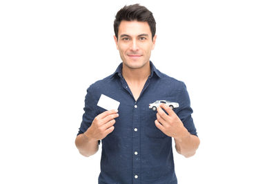 Portrait of smiling young man against white background