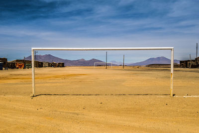 View of soccer field against cloudy sky