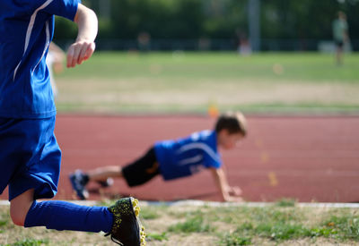 Low section of man playing with ball on field