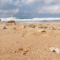 Surface level of beach against sky