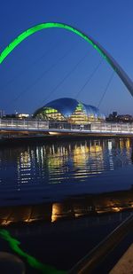 Illuminated city at waterfront