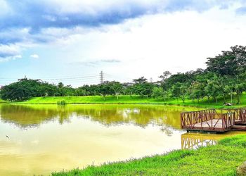 Scenic view of lake against cloudy sky