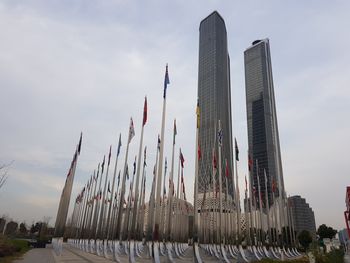 Low angle view of modern building against cloudy sky