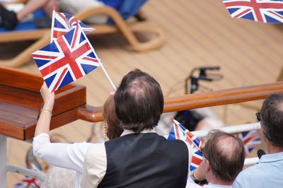 High angle view of people with british flags in city