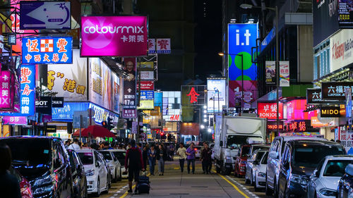 Cars on city street at night